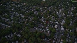 5.5K aerial stock footage flying over a suburban neighborhood, trees, Hyde Park, Massachusetts, twilight Aerial Stock Footage | AX141_005E