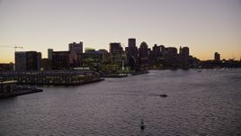 5.5K aerial stock footage flying by skyline and out over the water, Downtown Boston, Massachusetts, twilight Aerial Stock Footage | AX141_021E