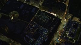 5.5K aerial stock footage of a bird's eye view over skyscrapers, city streets, Downtown Boston, Massachusetts, night Aerial Stock Footage | AX141_054E