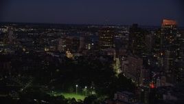 5.5K aerial stock footage flying by Massachusetts State House, skyscrapers, Downtown Boston, Massachusetts, night Aerial Stock Footage | AX141_056E