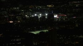 5.5K aerial stock footage flying by buildings, skyscrapers, baseball game at Fenway Park, Boston, Massachusetts, night Aerial Stock Footage | AX141_134