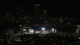 5.5K aerial stock footage flying by lights of Fenway Park, Downtown Boston, Massachusetts, night Aerial Stock Footage | AX141_142