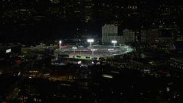5.5K aerial stock footage flying by bright lights of baseball game, Fenway Park, Boston, Massachusetts, night Aerial Stock Footage | AX141_170E