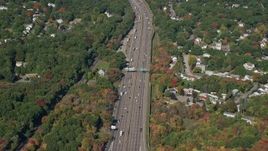 5.5K aerial stock footage flying by Interstate 93, homes, trees, autumn, Westwood, Massachusetts Aerial Stock Footage | AX142_005E
