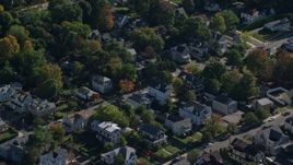 5.5K aerial stock footage flying over homes, small town, colorful trees in autumn, Hyde Park, Massachusetts Aerial Stock Footage | AX142_010E