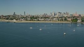 5.5K aerial stock footage flying by coastal community, anchored boats, skyline, South Boston, Massachusetts Aerial Stock Footage | AX142_215