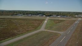 5.5K aerial stock footage approaching and flying over airport in autumn, Norwood Memorial Airport, Massachusetts Aerial Stock Footage | AX142_325E