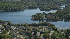 5.5K aerial stock footage flying by small town, Whitmans Pond, autumn, Weymouth, Massachusetts Aerial Stock Footage | AX143_014E