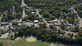 5.5K aerial stock footage flying by small town, roads, shops and homes in autumn, Weymouth, Massachusetts Aerial Stock Footage | AX143_016
