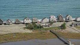 5.5K aerial stock footage flying by elevated oceanfront homes, Humarock, Massachusetts Aerial Stock Footage | AX143_049