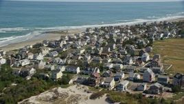 5.5K aerial stock footage flying by oceanfront homes, waves crashing, Marshfield, Massachusetts Aerial Stock Footage | AX143_054E