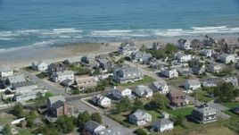 5.5K aerial stock footage flying by oceanfront homes, waves crashing, Marshfield, Massachusetts Aerial Stock Footage | AX143_055