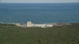 5.5K aerial stock footage flying by Pilgrim Nuclear Generating Station, Cape Cod Bay, Plymouth, Massachusetts Aerial Stock Footage | AX143_114E