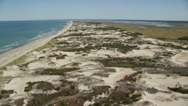 5.5K aerial stock footage approaching and flying over a beach and sand dunes, Barnstable, Massachusetts Aerial Stock Footage | AX143_131E