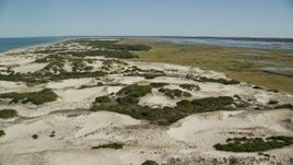 5.5K aerial stock footage flying over sand dunes, beach and isolated home, Barnstable, Cape Cod, Massachusetts Aerial Stock Footage | AX143_134E