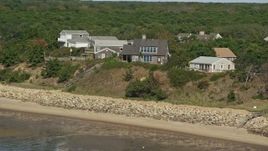 5.5K aerial stock footage flying by hilltop, beachfront hoes, Cape Cod, Eastham, Massachusetts Aerial Stock Footage | AX143_186