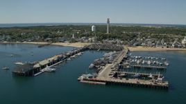 5.5K aerial stock footage flying by piers, small coastal town, Provincetown, Massachusetts Aerial Stock Footage | AX143_222E
