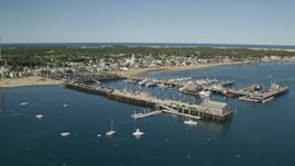 5.5K aerial stock footage orbiting piers, near small coastal town, Provincetown, Massachusetts Aerial Stock Footage | AX143_224E