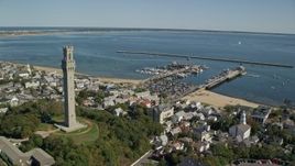 5.5K aerial stock footage orbiting Pilgrim Monument, small coastal town, Provincetown, Massachusetts Aerial Stock Footage | AX143_226E