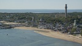 5.5K aerial stock footage orbiting small coastal town, reveal Pilgrim Monument, Provincetown, Massachusetts Aerial Stock Footage | AX143_241E