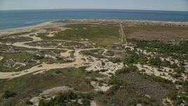 5.5K aerial stock footage flying by sand dunes, marshland, Cape Cod, Provincetown, Massachusetts Aerial Stock Footage | AX143_253E