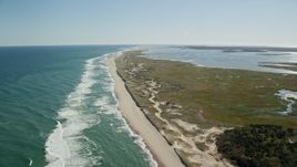5.5K aerial stock footage flying over waves, beaches, approaching marshlands, Orleans, Massachusetts Aerial Stock Footage | AX144_039E
