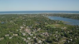 5.5K aerial stock footage flying by small coastal town, dense green trees, Chatham, Massachusetts Aerial Stock Footage | AX144_052E