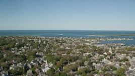 5.5K aerial stock footage flying by small coastal community, Nantucket Harbor, Nantucket, Massachusetts Aerial Stock Footage | AX144_096E