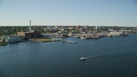 6k aerial stock footage of a pier, fishing boats, coastal community, factories, New Bedford, Massachusetts Aerial Stock Footage | AX144_192E