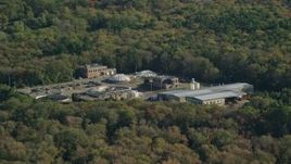 6k aerial stock footage flying by water treatment plant, dense trees, Dartmouth, Massachusetts Aerial Stock Footage | AX144_211