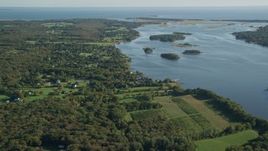 6k aerial stock footage flying by rural coastal neighborhood, tiny islands in bay, Westport, Massachusetts Aerial Stock Footage | AX144_216