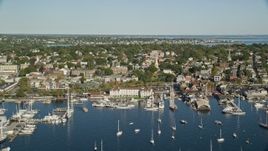 6k aerial stock footage flying by coastal community, piers, busy harbor, Newport, Rhode Island Aerial Stock Footage | AX144_232E