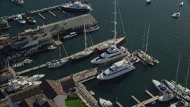 6k aerial stock footage approaching piers, tilt to bird's eye view over boats, Newport, Rhode Island Aerial Stock Footage | AX144_238