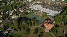 6k aerial stock footage flying by strip mall, tennis courts, Edward King House, Newport, Rhode Island Aerial Stock Footage | AX144_240E