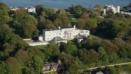 6k aerial stock footage flying by mansion surrounded by large trees, Newport, Rhode Island Aerial Stock Footage | AX144_247
