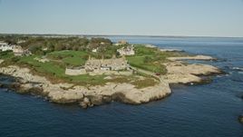 6k aerial stock footage flying by oceanfront mansion, coastal cliffs, Newport, Rhode Island Aerial Stock Footage | AX144_252