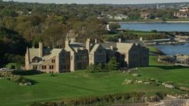 6k aerial stock footage flying by Rough Point, oceanfront mansion, rocky coast, Newport, Rhode Island Aerial Stock Footage | AX144_253