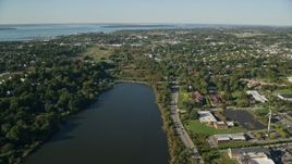 6k aerial stock footage approaching a coastal community, green trees, Newport, Rhode Island Aerial Stock Footage | AX144_260E