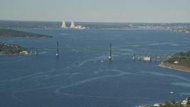 6k aerial stock footage flying by Mount Hope Bridge, Dynegy Brayton Point, Portsmouth, Rhode Island Aerial Stock Footage | AX145_009E