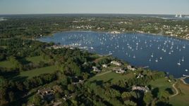 6k aerial stock footage flying by waterfront mansions, Bristol Harbor, sailboats, Bristol, Rhode Island Aerial Stock Footage | AX145_013