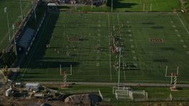 6k aerial stock footage approaching a football practice, Brown University, Providence, Rhode Island Aerial Stock Footage | AX145_064E