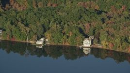 6k aerial stock footage flying by waterfront homes, Lake Mirimichi, autumn, Plainville, Massachusetts Aerial Stock Footage | AX145_106