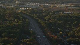 6k aerial stock footage flying by Interstate 93, heavy traffic, autumn, Westwood, Massachusetts, sunset Aerial Stock Footage | AX146_003E