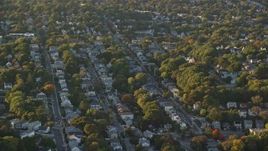 6k aerial stock footage flying by suburban neighborhood, autumn, Roslindale, Massachusetts, sunset Aerial Stock Footage | AX146_008