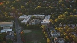6k aerial stock footage flying by Brookline High School, Brookline, Massachusetts, sunset Aerial Stock Footage | AX146_013