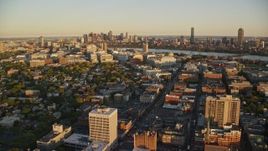 6k aerial stock footage flying by neighborhoods, Downtown Boston skyline, Cambridge, Massachusetts, sunset Aerial Stock Footage | AX146_046E