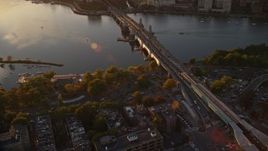 6k aerial stock footage flying by the Longfellow Bridge, Charles River, Boston, Massachusetts, sunset Aerial Stock Footage | AX146_066