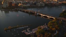 6k aerial stock footage a commuter train crossing the Longfellow Bridge, Boston, Massachusetts, sunset Aerial Stock Footage | AX146_067