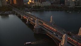 6k aerial stock footage tracking a commuter train across the Longfellow Bridge, Boston, Massachusetts, sunset Aerial Stock Footage | AX146_068E