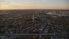 6k aerial stock footage flying by row house, Bunker Hill Monument, Charlestown, Massachusetts, sunset Aerial Stock Footage | AX146_073E